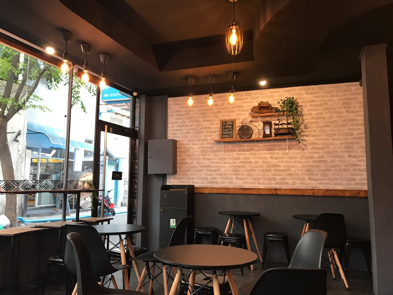 A stylish cafe interior featuring modern furniture and ambient lighting for a cozy atmosphere.